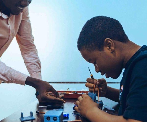 Child Learning Electronics in Classroom Setting